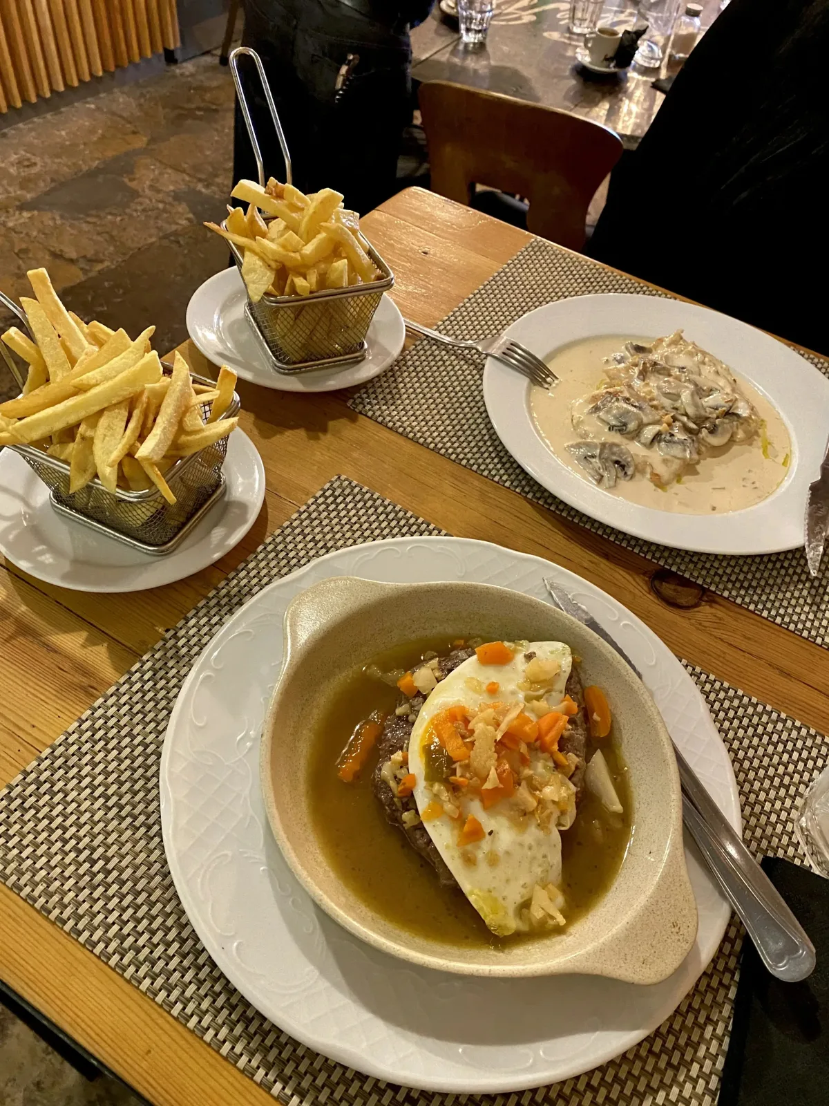 Portuguese style steak with egg and homemade fries + chicken scallops with mushroom sauce